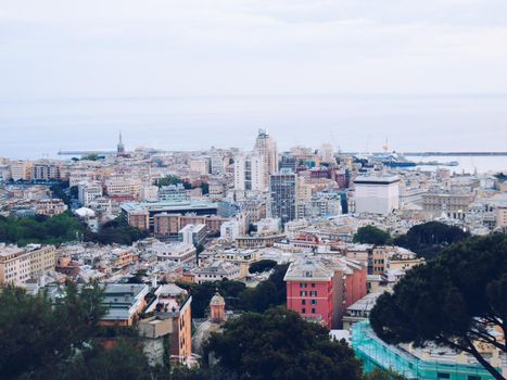 Genova, Italy- June 20,2022: Port of Porto Antico harbor with luxury yachts and attractions, Bigo construction in historical centre of old european city Genoa with beautiful sunset reflection.