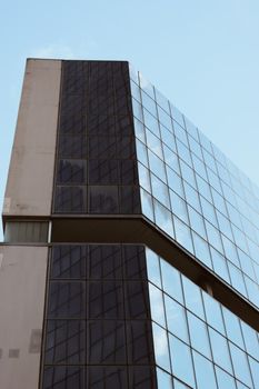 Genova, Italy-January 29, 2022: Beautiful modern high-rise buildings against the sky. 3d illustration on the theme of business success and technology. clouds reflection on the mirror.Industrial zone.