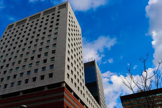 Genova, Italy-January 29, 2022: Beautiful modern high-rise buildings against the sky. 3d illustration on the theme of business success and technology. clouds reflection on the mirror.Industrial zone.