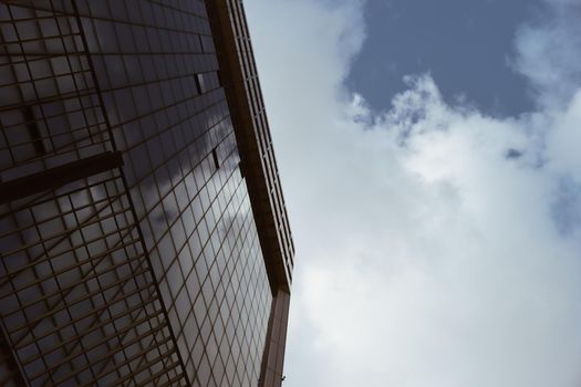 Genova, Italy-January 29, 2022: Beautiful modern high-rise buildings against the sky. 3d illustration on the theme of business success and technology. clouds reflection on the mirror.Industrial zone.