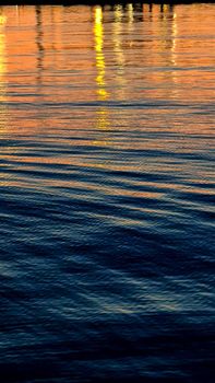 Genova, Italy- June 20,2022: Port of Porto Antico harbor with luxury yachts and attractions, Bigo construction in historical centre of old european city Genoa with beautiful sunset reflection.