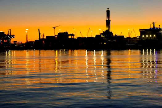 Genova, Italy- June 20,2022: Port of Porto Antico harbor with luxury yachts and attractions, Bigo construction in historical centre of old european city Genoa with beautiful sunset reflection.