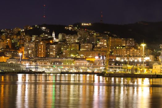 Genova, Italy- June 20,2022: Port of Porto Antico harbor with luxury yachts and attractions, Bigo construction in historical centre of old european city Genoa with beautiful sunset reflection.