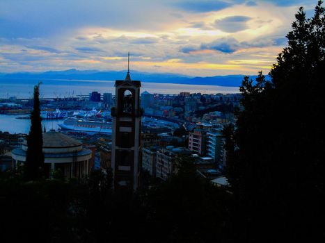 Genova, Italy- June 20,2022: Port of Porto Antico harbor with luxury yachts and attractions, Bigo construction in historical centre of old european city Genoa with beautiful sunset reflection.