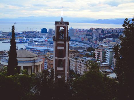 Genova, Italy- June 20,2022: Port of Porto Antico harbor with luxury yachts and attractions, Bigo construction in historical centre of old european city Genoa with beautiful sunset reflection.