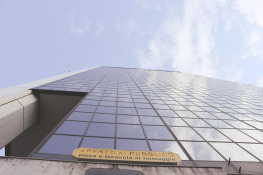 Genova, Italy-January 29, 2022: Beautiful modern high-rise buildings against the sky. 3d illustration on the theme of business success and technology. clouds reflection on the mirror.Industrial zone.