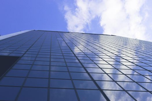 Genova, Italy-January 29, 2022: Beautiful modern high-rise buildings against the sky. 3d illustration on the theme of business success and technology. clouds reflection on the mirror.Industrial zone.