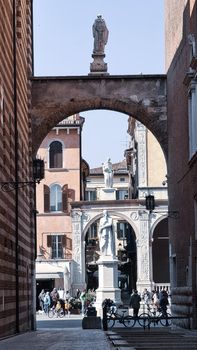 ROME, ITALY - February 05, 2022: Panoramic view around the Colosseum in city of Rome, Italy. Cold and gray sky in the background. Macro photography of the green parks with the old buildings.