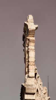 ROME, ITALY - February 05, 2022: Panoramic view around the Colosseum in city of Rome, Italy. Cold and gray sky in the background. Macro photography of the green parks with the old buildings.