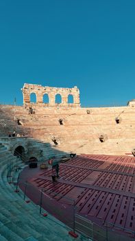 Verona, Italy-March 19, 2022: Beautifull old buildings of Verona. Typical architecture of the medieval period. Aerial view to the city with blue sky in the background. Detailed photography of the old architecture.