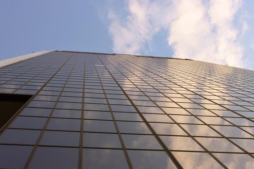 Genova, Italy-January 29, 2022: Beautiful modern high-rise buildings against the sky. 3d illustration on the theme of business success and technology. clouds reflection on the mirror.Industrial zone.