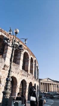 Verona, Italy-March 19, 2022: Beautifull old buildings of Verona. Typical architecture of the medieval period. Aerial view to the city with blue sky in the background. Detailed photography of the old architecture.