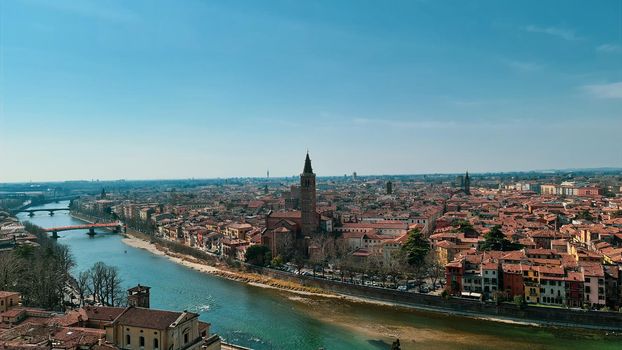 Verona, Italy-March 19, 2022: Beautifull old buildings of Verona. Typical architecture of the medieval period. Aerial view to the city with blue sky in the background. Detailed photography of the old architecture.