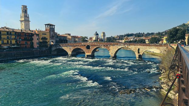 Verona, Italy-March 19, 2022: Beautifull old buildings of Verona. Typical architecture of the medieval period. Aerial view to the city with blue sky in the background. Detailed photography of the old architecture.