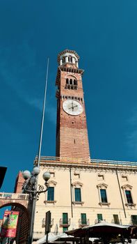 Verona, Italy-March 19, 2022: Beautifull old buildings of Verona. Typical architecture of the medieval period. Aerial view to the city with blue sky in the background. Detailed photography of the old architecture.