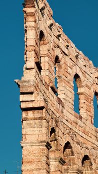 Verona, Italy-March 19, 2022: Beautifull old buildings of Verona. Typical architecture of the medieval period. Aerial view to the city with blue sky in the background. Detailed photography of the old architecture.