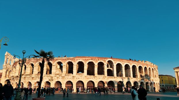 ROME, ITALY - February 05, 2022: Panoramic view of inside part of Colosseum in city of Rome, Italy. Cold and gray sky in the background. Macro photography of the arches.