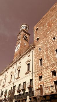 Verona, Italy - March 19, 2022: Aerial view of Verona historical city centre, Ponte Pietra bridge across Adige river, Verona Cathedral, Duomo di Verona, red tiled roofs, Veneto Region, Italy.