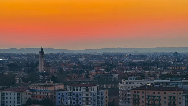 ROME, ITALY - February 05, 2022: Panoramic view around the Colosseum in city of Rome, Italy. Cold and gray sky in the background. Macro photography of the green parks with the old buildings.