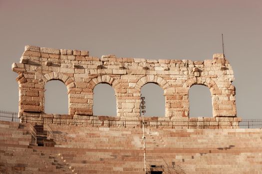 Verona, Italy - March 19, 2022: Beautiful photography of the Arena at Piazza Brà in Verona, a famous Roman amphitheater. Macro view of the old construction by day.