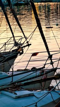 Genova, Italy - May 07, 2022: Panoramic view from the sea to the old town, and the port with beautiful sunset. Genoa bay, harbor, yacht at the pier.tourist destinations.