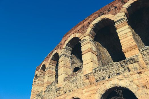 Verona, Italy - March 19, 2022: Beautiful photography of the Arena at Piazza Brà in Verona, a famous Roman amphitheater. Macro view of the old construction by day.