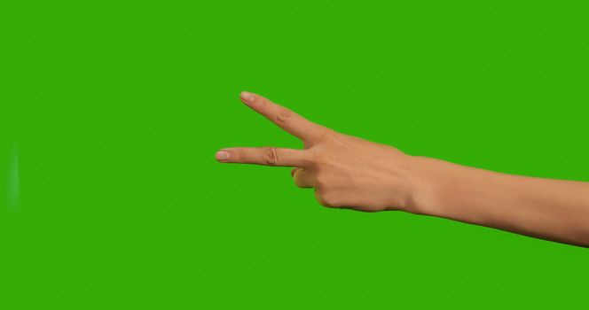 Gestures female Hand, the symbol of peace on a Green Background, Green Screen, Chroma Key Close-up. Make symbols with hand on Greenscreen.