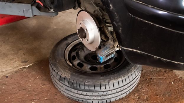 Replacing a new car brake disc. Auto repair concept.
