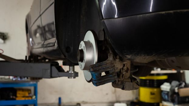 Replacing a new brake disc on a old car. Auto repair and maintenance concept.