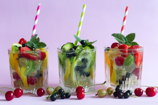 Summer refreshing cocktail of natural fruits and various berries with ice and mint leaves infused with water. Contains lemon, orange, strawberry, cherry, currant.