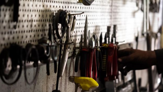 Various mechanical tools. Professional car mechanic using kit tools for working in the car repair service.