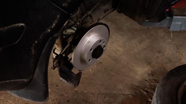 Replacing a new car brake disc. Auto repair concept.