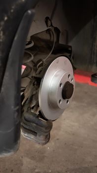 Installing a new brake disc. Auto repair concept. Vertical shot.