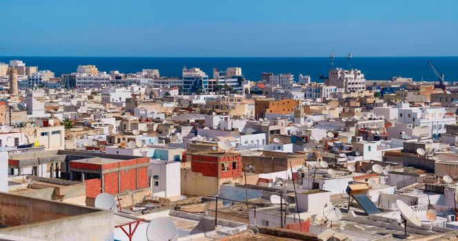 View of Tunisian cityscape of houses near to port of Sousse. Many satellite dish, antennas on private houses.