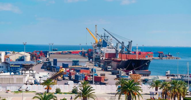 International containers cargo ship loading and unloading in Port of Sousse, Tunisia. Freight transportation, shipping, nautical vessel. Oversea Transport business