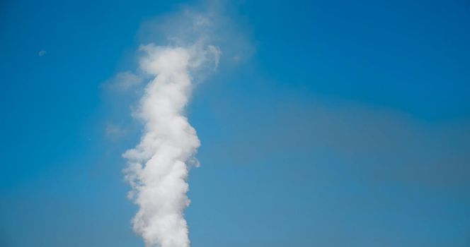 SMOKE Pollute Industry Atmosphere With Smoke Ecology pollution, Industrial Factory Pollutes. Smoke details on blue sky background.