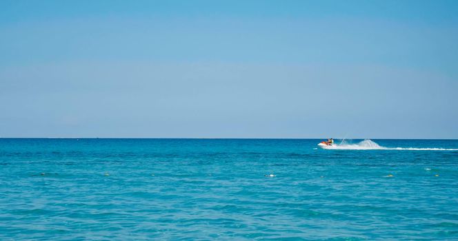 Water scooter on blue. People enjoy summer days riding jet skis, Tunisia, Africa, Mediterranean sea. Summer and travel vacation concept. Vacation activities at sea.