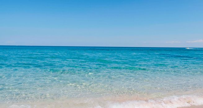 View of crystal clear sea and white sand beach. Looping Water surface texture, View ocean waves slow motion, Sea side white sand, Sun shine water seamless loop background.