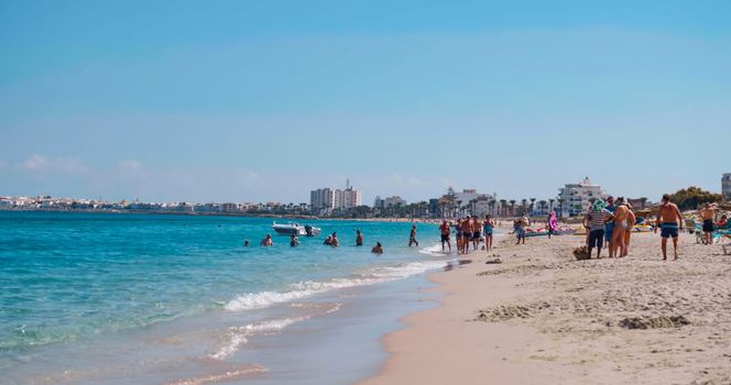 Tunisia, 2022: Summertime scene on a beautiful beach with many people. Holiday destination in Tunisia. Mediterranean sea.