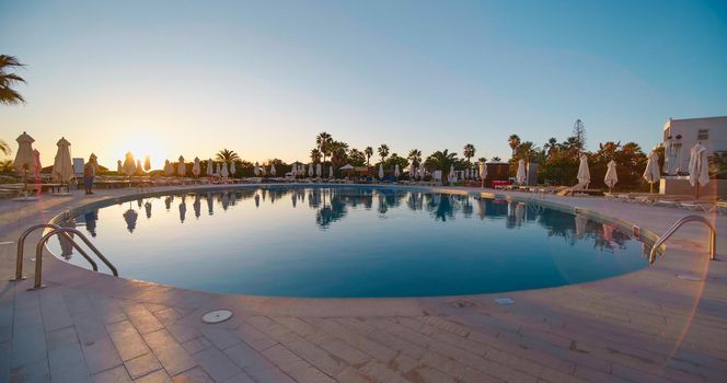 Pool area and bars in Tunisia, Africa. Tropical tourist resort. Hotel with exotic poolside. Vacation, tourist destination, holiday concept.