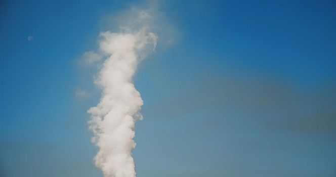 SMOKE Pollute Industry Atmosphere With Smoke Ecology pollution, Industrial Factory Pollutes. Global Warming. Smoke details on blue sky background.