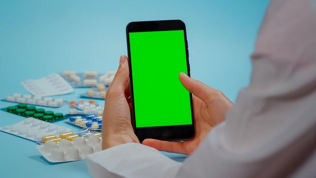 Phone with Chroma Key Display for Medication Information. Pharmaceutical Concept. Smarthphone with Mockup, Green Screen Medical. Pills blisters.