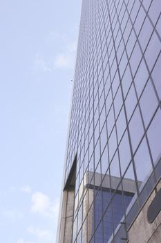 Genova, Italy-January 29, 2022: Beautiful modern high-rise buildings against the sky. 3d illustration on the theme of business success and technology. clouds reflection on the mirror.Industrial zone.