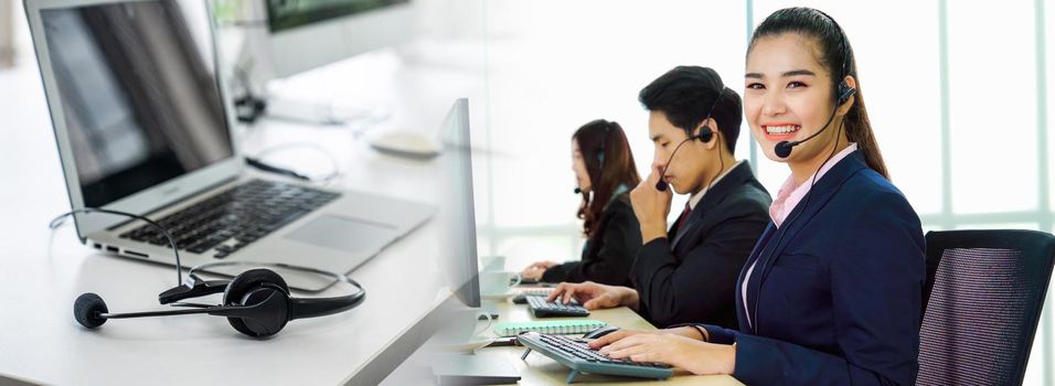 Business people wearing headset working in office in widen view to support remote customer or colleague. Call center, telemarketing, customer support agent provide service on telephone video call.