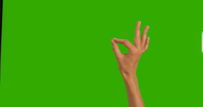 Gestures female Hand OKAY OK Everything is Good on a Green Background, Green Screen, Chroma Key Close-up. Make symbols with hand on Greenscreen.