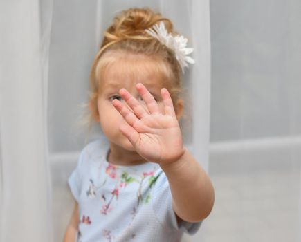 The little girl covers her face with her hand. Please, no picture.