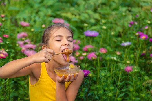 The child eats flower honey. Selective focus. Nature.