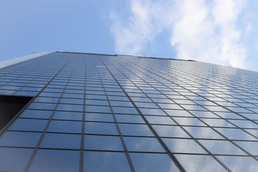 Genova, Italy-January 29, 2022: Beautiful modern high-rise buildings against the sky. 3d illustration on the theme of business success and technology. clouds reflection on the mirror.Industrial zone.