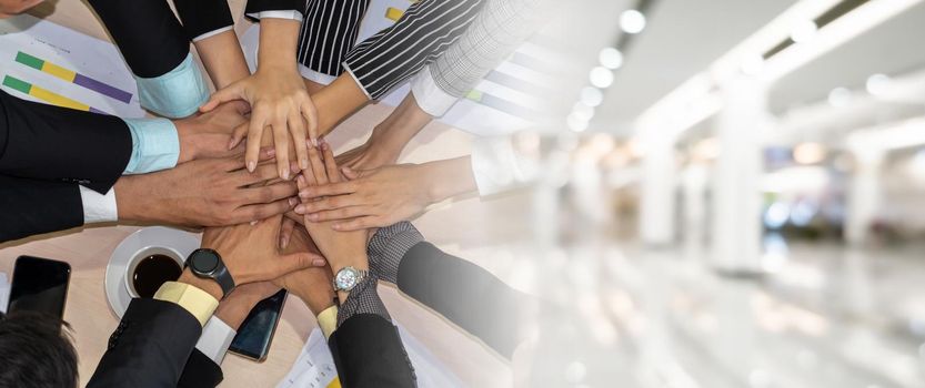 Happy business people celebrate teamwork success together with joy at office table shot from top view . Young businessman and businesswoman workers express cheerful victory in broaden view .