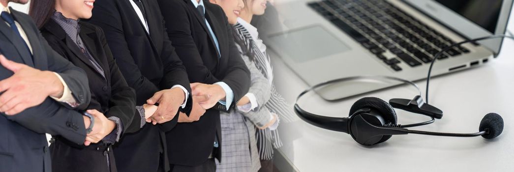 Successful business people standing together showing strong relationship of worker community. A team of businessman and businesswoman expressing a strong group teamwork at office broaden view